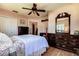 Bedroom showcasing a spindle bed, wooden dresser, and bright natural light at 5072 98Th Way, St Petersburg, FL 33708