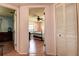 View into bedroom with hardwood floors, ceiling fan, and classic spindle bed at 5072 98Th Way, St Petersburg, FL 33708