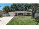 Charming ranch-style home with a brick driveway and mature trees offering shade at 5072 98Th Way, St Petersburg, FL 33708