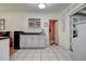 Spacious kitchen featuring checkered tile and a convenient doorway, ready for Gathering meals at 5072 98Th Way, St Petersburg, FL 33708