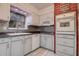 Charming kitchen featuring updated appliances, ample cabinet space, and tiled backsplash at 5072 98Th Way, St Petersburg, FL 33708