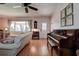 Cozy room showcasing natural light, hardwood flooring, piano, and comfortable seating at 5072 98Th Way, St Petersburg, FL 33708
