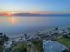 Aerial view showcasing the Gulf beaches with beachfront parking, cabanas, and sunset views at 5537 Sea Forest Dr # 304, New Port Richey, FL 34652