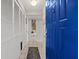 Hallway featuring tile floors and a blue front door at 5537 Sea Forest Dr # 304, New Port Richey, FL 34652