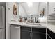 Kitchen area featuring stainless steel appliances, light countertops, dark cabinets, and breakfast bar with seating at 5537 Sea Forest Dr # 304, New Port Richey, FL 34652