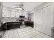 Bright kitchen featuring stainless steel appliances, granite countertops, and white cabinets with black trim at 5537 Sea Forest Dr # 304, New Port Richey, FL 34652