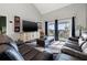 Comfortable living room with plush seating, large TV, and sliding doors to a private balcony with a water view at 5537 Sea Forest Dr # 304, New Port Richey, FL 34652