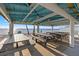 Charming beach pavilion featuring picnic tables and protection from the sun at 5537 Sea Forest Dr # 304, New Port Richey, FL 34652