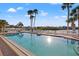 Lovely community pool area providing a tranquil escape with lounge chairs, sun, and serene water views at 5537 Sea Forest Dr # 304, New Port Richey, FL 34652