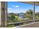 Stunning view from the enclosed porch showcasing the tranquil waters and lush landscaping at 5537 Sea Forest Dr # 304, New Port Richey, FL 34652