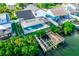Expansive backyard with a screened pool, boat dock, and lush greenery, perfect for waterfront living at 6509 Dolphin Cove Dr, Apollo Beach, FL 33572