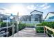 Backyard view from dock featuring patio, pool, and canal-front property at 6509 Dolphin Cove Dr, Apollo Beach, FL 33572