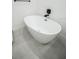A modern soaking tub features sleek fixtures and neutral tile at 6509 Dolphin Cove Dr, Apollo Beach, FL 33572