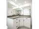 Bright bathroom with a double vanity, gray countertops, and a large mirror at 6509 Dolphin Cove Dr, Apollo Beach, FL 33572