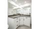 Modern bathroom vanity features gray counters, white cabinets, and expansive mirror at 6509 Dolphin Cove Dr, Apollo Beach, FL 33572