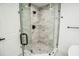 Bathroom boasts a glass shower with gray tile and dark hardware at 6509 Dolphin Cove Dr, Apollo Beach, FL 33572
