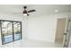 Bright bedroom boasts a ceiling fan and a sliding glass door to a balcony overlooking the pool at 6509 Dolphin Cove Dr, Apollo Beach, FL 33572