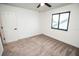 Bright bedroom with neutral carpet, white walls, window and ceiling fan at 6509 Dolphin Cove Dr, Apollo Beach, FL 33572
