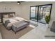Bright bedroom features waterfront views, a ceiling fan, and neutral decor at 6509 Dolphin Cove Dr, Apollo Beach, FL 33572