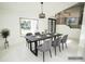 Elegant dining area showcases a sleek table setting, large window, and views into the neighboring landscape at 6509 Dolphin Cove Dr, Apollo Beach, FL 33572