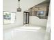 Elegant entryway features high ceilings, modern lighting, and a stylish staircase with sleek railings at 6509 Dolphin Cove Dr, Apollo Beach, FL 33572
