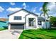 Charming two-story home with a manicured lawn and modern architectural details, showcasing curb appeal at 6509 Dolphin Cove Dr, Apollo Beach, FL 33572