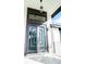 Modern front entry with a statement door, contemporary lighting, and sleek design details at 6509 Dolphin Cove Dr, Apollo Beach, FL 33572