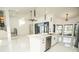 Open-concept kitchen features a large island, stainless steel appliances, and modern light fixtures at 6509 Dolphin Cove Dr, Apollo Beach, FL 33572