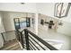 Elevated view of the home's open-concept living area, modern kitchen, and staircase at 6509 Dolphin Cove Dr, Apollo Beach, FL 33572