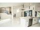 Modern kitchen with white cabinetry, stainless steel appliances, and an open layout to the living area at 6509 Dolphin Cove Dr, Apollo Beach, FL 33572