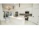 Stylish kitchen with white cabinetry, stainless steel appliances, island sink and black pendant lighting at 6509 Dolphin Cove Dr, Apollo Beach, FL 33572