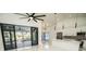 Bright interior showing the kitchen and living area with modern finishings and sliding doors to screened porch at 6509 Dolphin Cove Dr, Apollo Beach, FL 33572