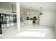 Open living space leading to a modern kitchen, bright with neutral tones and large windows for natural light at 6509 Dolphin Cove Dr, Apollo Beach, FL 33572