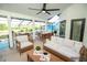 Inviting outdoor patio with comfortable seating, ceiling fan, and views of the lake and surrounding landscape at 6509 Dolphin Cove Dr, Apollo Beach, FL 33572