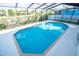 Large backyard swimming pool is completely enclosed in a screen at 6509 Dolphin Cove Dr, Apollo Beach, FL 33572