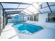 Private in-ground pool with a screened enclosure and brick border for low maintenance at 6509 Dolphin Cove Dr, Apollo Beach, FL 33572