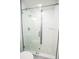 Updated tile shower features glass doors and neutral color palette at 6509 Dolphin Cove Dr, Apollo Beach, FL 33572
