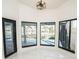Bright sunroom with large windows offering waterfront and pool views and black framed doors at 6509 Dolphin Cove Dr, Apollo Beach, FL 33572