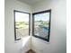 Corner of a room showcasing scenic water views through modern black frame windows at 6509 Dolphin Cove Dr, Apollo Beach, FL 33572