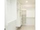 Spacious walk-in closet featuring custom shelving, drawers, and ample storage space at 6509 Dolphin Cove Dr, Apollo Beach, FL 33572