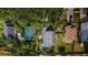 Aerial view of home and backyard pool amidst tree cover in a residential neighborhood at 678 Greenglen Ln, Palm Harbor, FL 34684