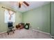Carpeted bedroom with a ceiling fan and a window with decorative curtains at 678 Greenglen Ln, Palm Harbor, FL 34684
