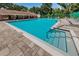 Beautiful community pool and entertaining area with ample seating and a bright blue pool at 678 Greenglen Ln, Palm Harbor, FL 34684