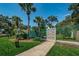 Community dog park with mature palms and an entrance gate at 678 Greenglen Ln, Palm Harbor, FL 34684