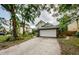 Two-story home featuring an attached garage and a spacious driveway amid lush landscaping at 678 Greenglen Ln, Palm Harbor, FL 34684