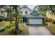 Charming home featuring lush landscaping, a two-car garage, and a beautifully maintained front yard at 678 Greenglen Ln, Palm Harbor, FL 34684
