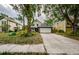Two-story home with well manicured lawn, driveway, and white garage door on a cloudy day at 678 Greenglen Ln, Palm Harbor, FL 34684