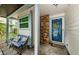 Inviting front porch with blue bench, brick accents, and charming front door at 678 Greenglen Ln, Palm Harbor, FL 34684