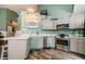 Bright kitchen with white countertops, stainless steel appliances and gray cabinets at 678 Greenglen Ln, Palm Harbor, FL 34684