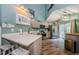 Modern kitchen with stainless steel appliances, gray cabinets, and plenty of counter space at 678 Greenglen Ln, Palm Harbor, FL 34684